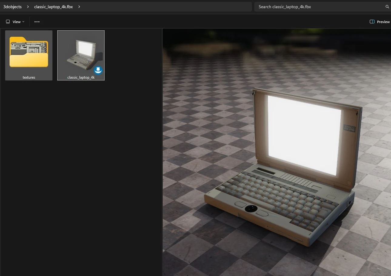 A folder in Windows Explorer holding an FBX of a classic laptop, its tile showing
              the rendered model and the preview pane showing it on a checkered floor.