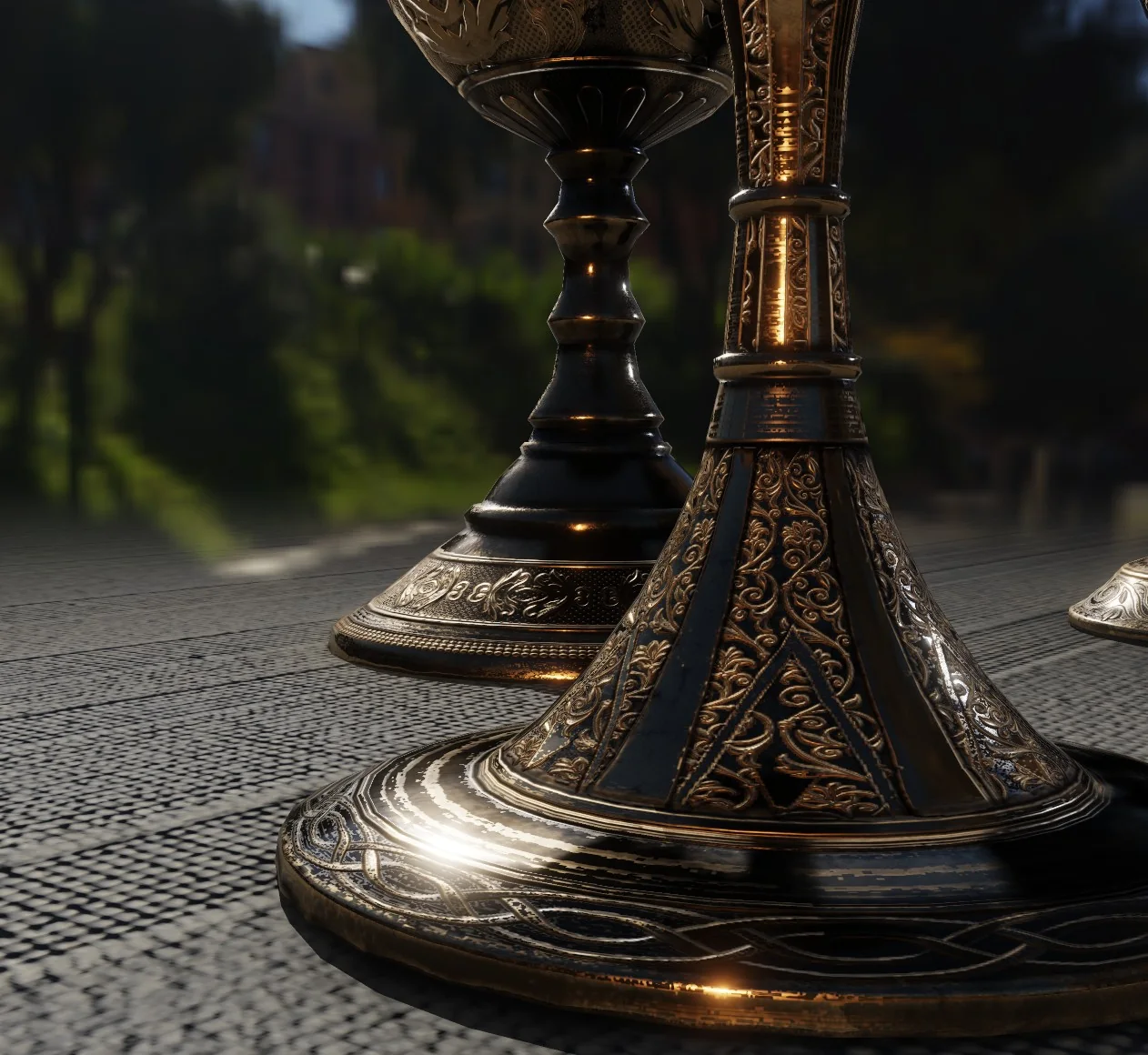 The engraved base of a brass goblet on a cobbled floor, the pattern staying
              distinct into the distance